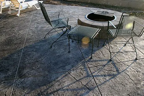 Seamless Stamped Concrete patio - natural with charcoal antiquing release agent. Firepit and patio by The Concrete Artisans, Inc